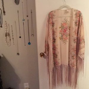 Pink floral poncho with knotted tassel fringe